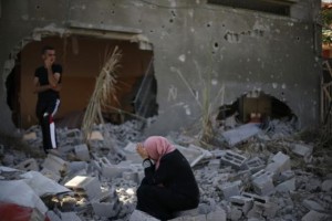 A Palestinian woman reacts upon seeing her destroyed house in Beit Hanoun town