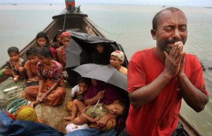 FILE - In this June 13, 2012 file photo, a Rohingya Muslim man who fled Myanmar to Bangladesh to escape religious violence, cries as he pleads from a boat after he and others were intercepted by Bangladeshi border authorities in Taknaf, Bangladesh. She is known as the voice of Myanmar's downtrodden but there is one oppressed group that Aung San Suu Kyi does not want to discuss. For weeks, Suu Kyi has dodged questions on the plight of a Muslim minority known as the Rohingya, prompting rare criticism of the woman whose struggle for democracy and human rights in Myanmar have earned her a Nobel Peace Prize, and adoration worldwide. (AP Photo/Anurup Titu, File)