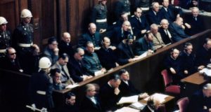 Defendants (in the two central rows) at the Nuremberg war crimes trials in 1946, including Hans Frank (front, fifth from right) ©Getty